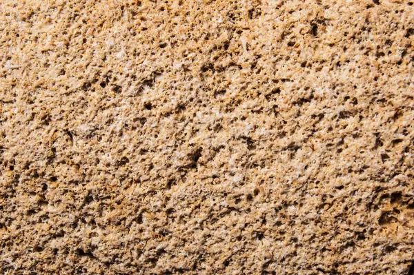 Arka plan ve tasarım için taş dokusu. Sert taş yüzey. Kum taşı. makro fotoğrafçılık.
