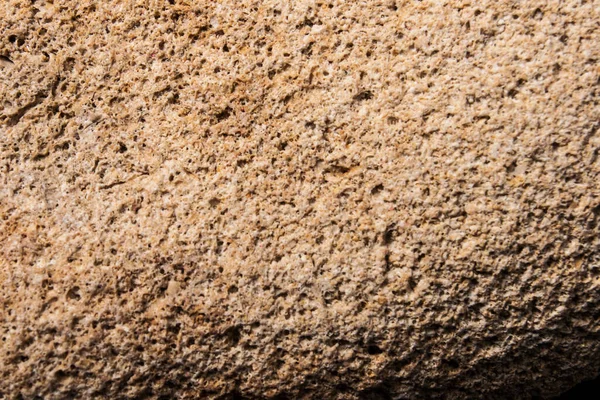 Arka plan ve tasarım için taş dokusu. Sert taş yüzey. Kum taşı. makro fotoğrafçılık.