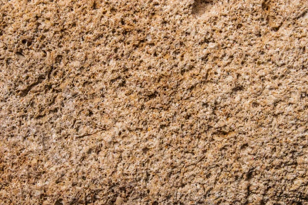 Arka plan ve tasarım için taş dokusu. Sert taş yüzey. Kum taşı. makro fotoğrafçılık.