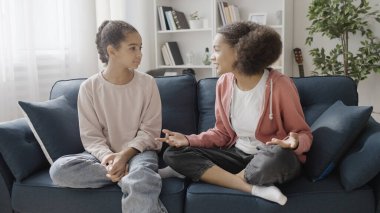 Olumlu kıvırcık saçlı kız arkadaşına haber veriyor ve sırlarını anlatıyor, kızlar dedikodu yapıyor.