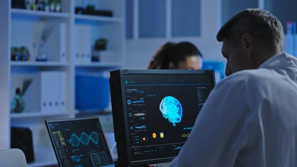 stock image Medical laboratory scientist studying patient's brain mri on computer, diagnostics