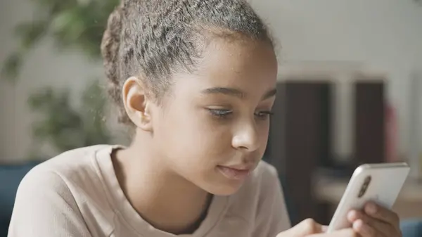 stock image Happy teen girl sending text message on smartphone, enjoying communication