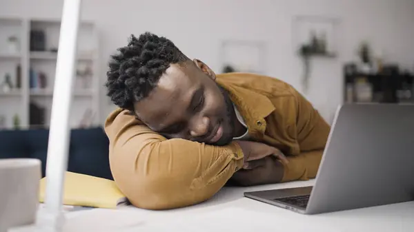 Young man fell asleep at workplace, exhaustion, procrastination, work from home