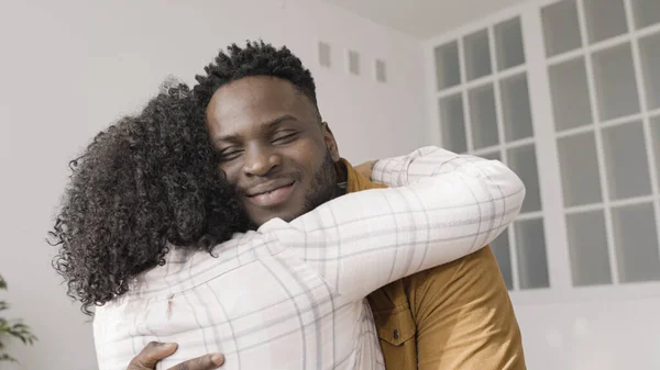 Happy African American woman hugs her partner to celebrate their anniversary