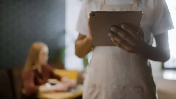 Restaurant worker receiving order on tablet, online booking service, technology