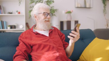 A pleasant man in his 60s talks with his relatives via a video call, embracing modern technology