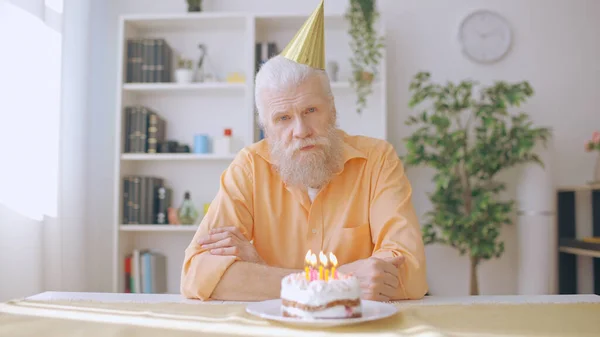 stock image Portrait of a sad man in his 60s commemorating his birthday alone, coronavirus lockdown