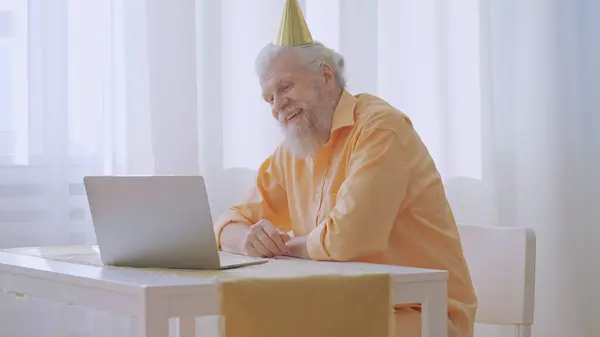 A lonely grandpa gratefully accepts birthday congratulations from relatives via a video call