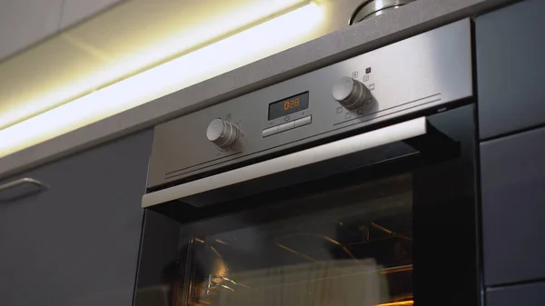 A bottom view of a modern electric oven, ready for cooking in a hi-tech kitchen design