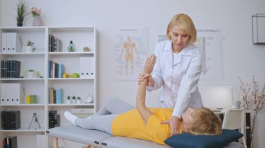 Rehabilitasyon doktoru, felç sonrası iyileşme sürecinde hastaya kas çalışmasında yardımcı olur.