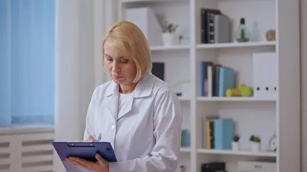 A focused physician devises a treatment plan, showcasing her expertise as a healthcare specialist in medicine