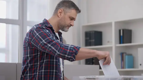 stock image Voter casting ballots into a box, fair presidential election in a democratic country