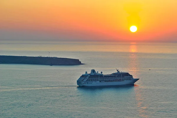 Giant cruiser ship on the sea. Sunset. Vacation on Santorini islands, Greece.