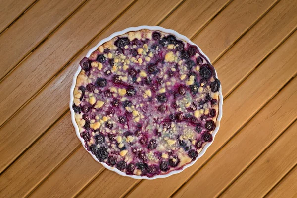 Fresh blueberry and cottage cheese pie on wooden table. Czech sweet dessert.