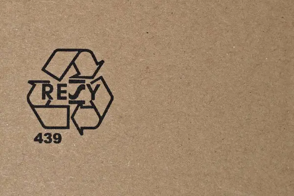 Recycling symbol on the cardboard box. Negative copy space for placement of text.