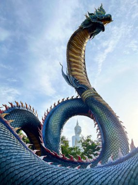 Naga King with Buddha Statue Beautiful Naga Statue, King of giant Naga statue at Wat Phu Manorom ,Mukdahan Province Thailand, Thai dragon or serpent king statue clipart