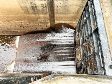 spillway gate of a concrete dam. This industrial structure channels water from a reservoir, demonstrating the controlled flow and discharge in a dam system, dam infrastructure clipart