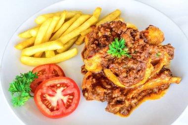 Patates kızartmasıyla servis edilen lezzetli domuz pirzolası.