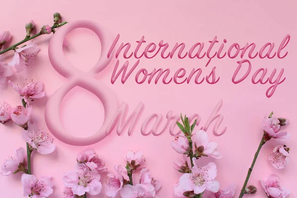 International women\'s day concept idea. Blossom tree branch and text 8 March isolated on pink background. Happy women\'s day.