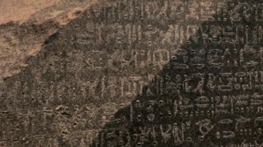 Close up of ancient text on big stone in historical museum