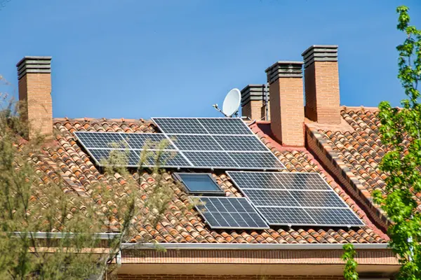 Solar panels on a roof with chimneys.