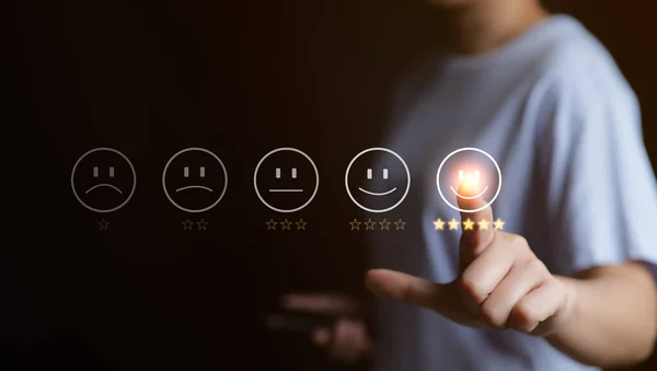 Customer service evaluation concept. User pressing smile face emoticon on virtual touch screen. quality review, feedback survey, best rating positive five star, marketing research, satisfaction client.