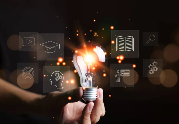 stock image Man holding lightbulb, E-learning graduate certificate program concept. Internet education course degree, study knowledge to creative thinking idea and problem solving solution,