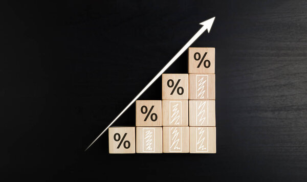 Business development to success and growing growth concept. Wooden blocks with percentage sign and arrow up, represent in meanings of interest rate increase, performance, sales, Achieving the goals.