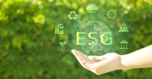 stock image ESG environmental social governance investment business concept. ESG icon in the hand for sustainable and ethical business on the Network connection on a green background.