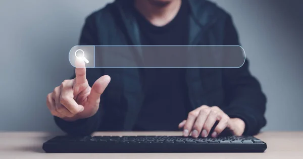 stock image Man finger showing a search bar virtual and hand on computer keyboard to Searching for information. Using Search Console with website. Data Search Technology Search Engine Optimization concept.