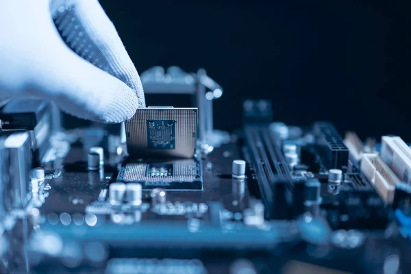 stock image Repairman computer Installation CPU on socket of the motherboard. Computer technology and hardware maintenance or repair.