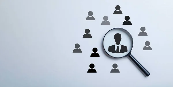 the concept of human resource management, Magnifier glass searching focus to manager icon which is among staff icons for human development recruitment leadership and organization.