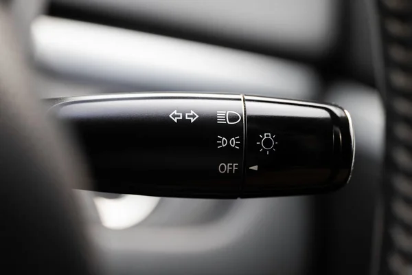 Turn signal lever, adjusting car headlight control switch.