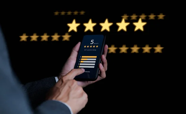 Customer review satisfaction feedback survey concept. Businessman or user giving a five star rating on smartphone online application. reputation ranking of business, service rating, service experience