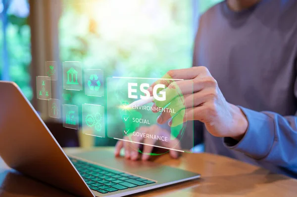 ESG environmental social governance investment business concept. Businessman using a computer for analysis of ESG Sustainability and corporate social responsibility. ESG report, CSR, Green business,