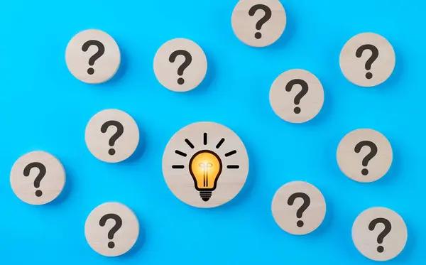 Problem solving concept. Question mark and light bulb icons on round wooden on blue background. Creative thinking, innovation, and idea, Business solution company, Find solution, Step idea process,