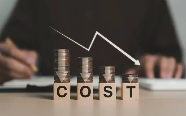 Cost reduction concept. Cost wording on decreasing coins stacking with the down arrow. Businessman working on company cost saving. Cost Management, Economy recession, Budget reduction, Low cost,