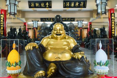 CHONBURI PROVINCE, THAILAND - JUNE 18, 2022. The laughing Buddha - known as Budai or Pu-tai. Eccentric buddhist monk of legendary generosity and joviality. Viharn Sien Chinese Temple and Museum.