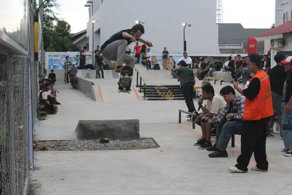 stock image a man performs skateboarding tricks on a ramp at the go skateboarding day event Indonesia - Medan, June 21, 2024