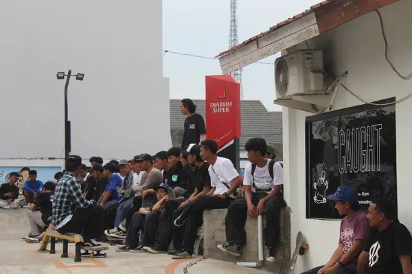 stock image a group of asian people watching a skateboarder do a trick. Indonesia - Medan, 21 June 2024