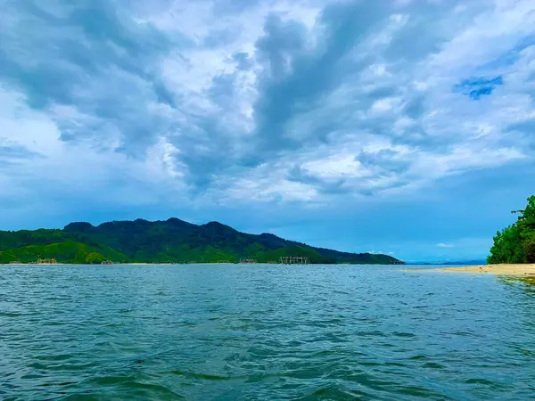 Hindistan cevizi ağaçları ve küçük adalı kumsal.