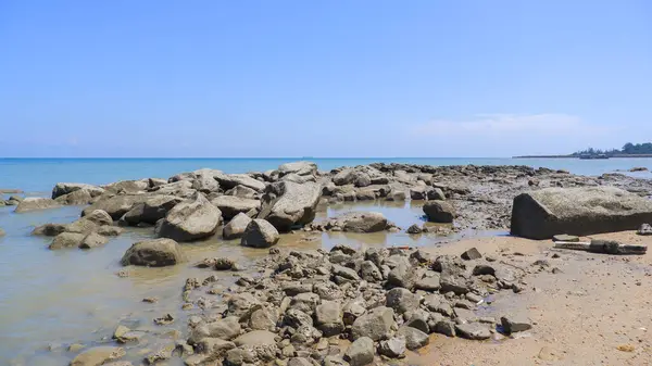 Charming Natural Scenery Of Piles Of Natural Rocks On The Edge Of Tanjung Kalian Beach, Indonesia