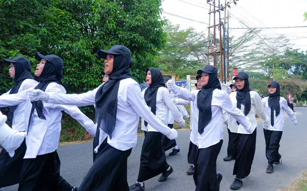 stock image MUNTOK,INDONESIA - SEPTEMBER 10, 2023 : High School Student Walking Competition Participants In Black And White Uniforms, At The Celebration Of Indonesian Independence Day