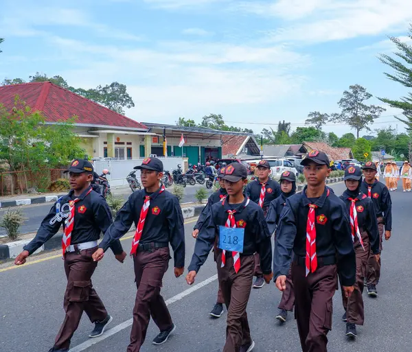 stock image MUNTOK,INDONESIA - SEPTEMBER 10, 2023 : Marching March Participants At High School Level, In Black And Brown Uniforms, At The Celebration Of Indonesian Independence