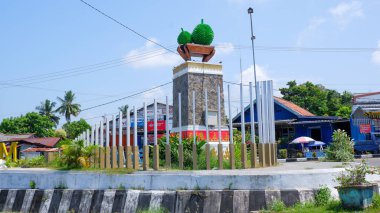 Durian monument with aluminum radius fence, in the middle of the road in Muntok city, Indonesia clipart