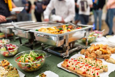 Close up of buffet table food in chafing dish at celebration event.