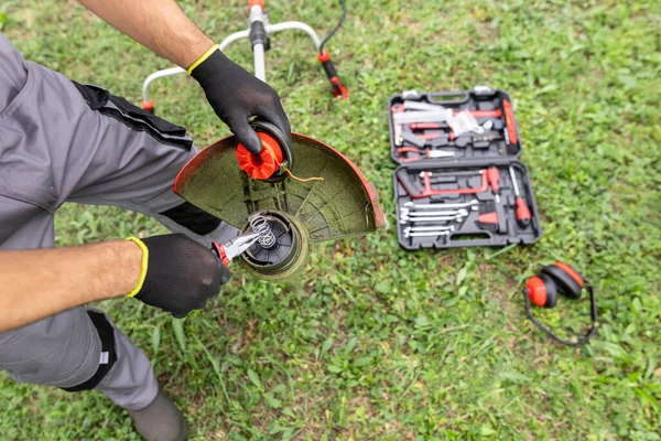 stock image Lawn mower repair. The lawn mower is defective. Maintenance of garden tools.