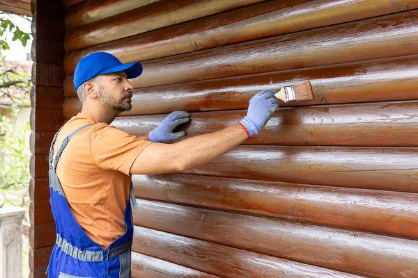 Wooden House Maintenance Concept Man Staining Wall Siding Trunk Fotografie de stoc