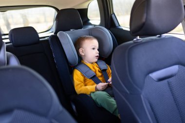 Arabanın arka koltuğunda oturan güzel bir çocuğun portresi..