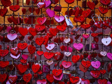 A romantic scene from Verona, Italyheart-shaped love locks attached to a metal fence, symbolizing eternal love.  clipart